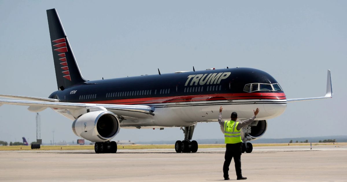 Donald Trump walking past Trump Tower after financial comeback.